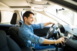 Man-Switching-Radio-Station-while-Driving-min